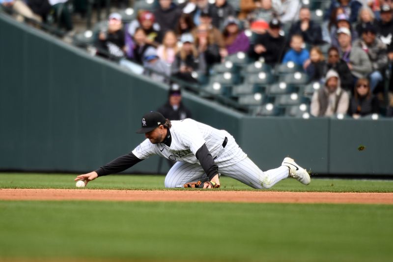 Apr 19, 2025; Denver, Colorado, USA; Colorado Rockies second base Kyle Farmer (6) is unable to field a ball on a play during the fourth inning against the Washington Nationals at Coors Field. Mandatory Credit: Christopher Hanewinckel-Imagn Images