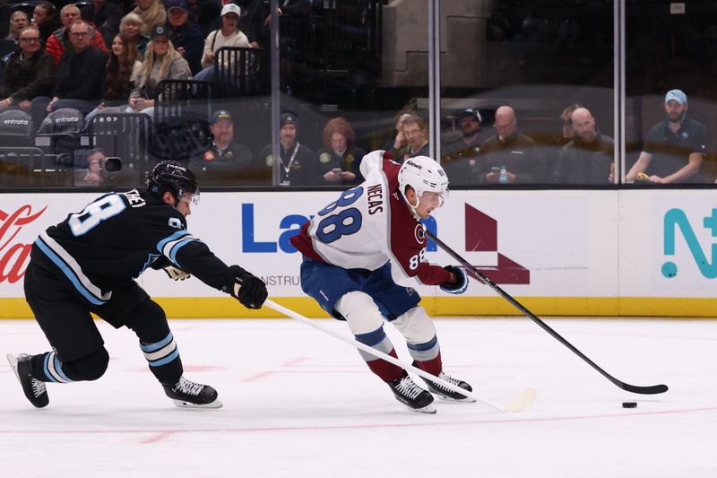 Oct 21, 2025; Salt Lake City, Utah, USA; Colorado Avalanche center Martin Necas (88) skates with the puck against Utah Mammoth defenseman Mikhail Sergachev (98) during the second period at Delta Center. Mandatory Credit: Rob Gray-Imagn Images
