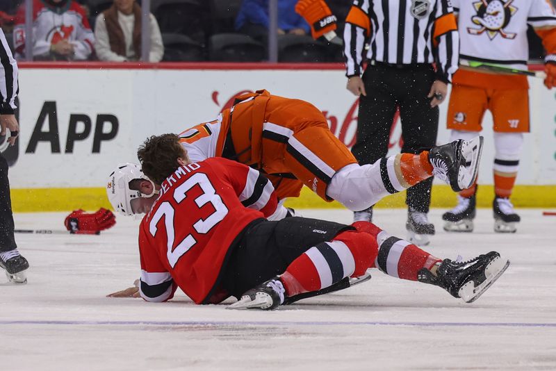 Oct 27, 2024; Newark, New Jersey, USA; Anaheim Ducks left wing Ross Johnston (44) and New Jersey Devils left wing Kurtis MacDermid (23) fight during the first period at Prudential Center. Mandatory Credit: Ed Mulholland-Imagn Images