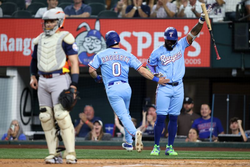 May 18, 2025; Arlington, Texas, USA; Texas Rangers outfielder Sam Haggerty (0) scores a run and is congratulated by designated hitter Adolis García (53) during the third inning against the Houston Astros at Globe Life Field. Mandatory Credit: Tim Heitman-Imagn Images