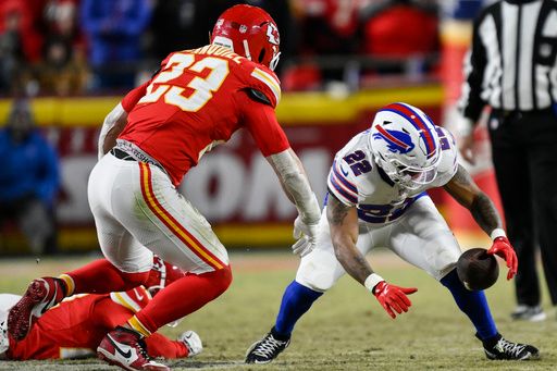 Buffalo Bills running back Ray Davis (22) recoveres his own fumble against Kansas City Chiefs linebacker Drue Tranquill (23) during the second half of the AFC Championship NFL football game, Sunday, Jan. 26, 2025, in Kansas City, Mo. (AP Photo/Reed Hoffmann)