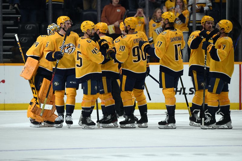 Mar 19, 2024; Nashville, Tennessee, USA; Nashville Predators players celebrate after a win against the San Jose Sharks at Bridgestone Arena. Mandatory Credit: Christopher Hanewinckel-USA TODAY Sports