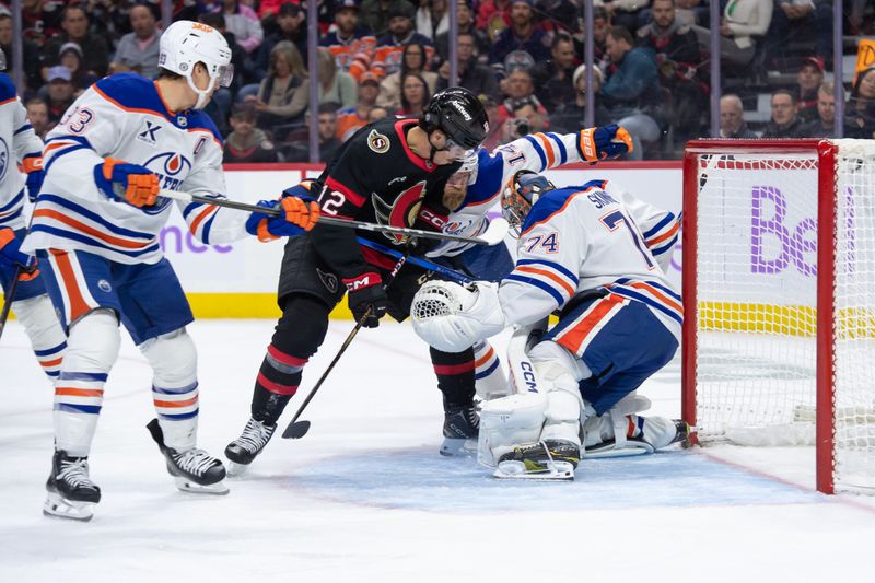 Nov 19, 2024; Ottawa, Ontario, CAN; Edmonton Oilers goalie Stuart Skinner (74) makes a save in front of Ottawa Senators center Shane Pinto (12) in the first period at the Canadian Tire Centre. Mandatory Credit: Marc DesRosiers-Imagn Images