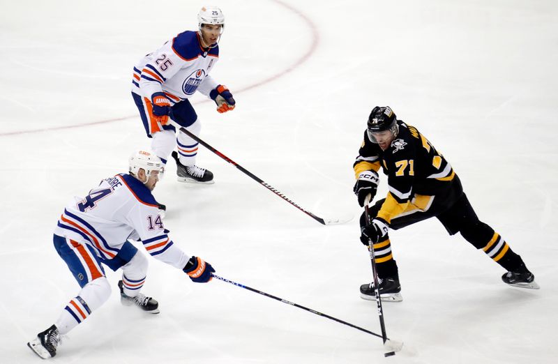 Feb 23, 2023; Pittsburgh, Pennsylvania, USA;  Pittsburgh Penguins center Evgeni Malkin (71) moves the puck against Edmonton Oilers center Devin Shore (14) and defenseman Darnell Nurse (25) during the second period at PPG Paints Arena. Edmonton won 7-2. Mandatory Credit: Charles LeClaire-USA TODAY Sports