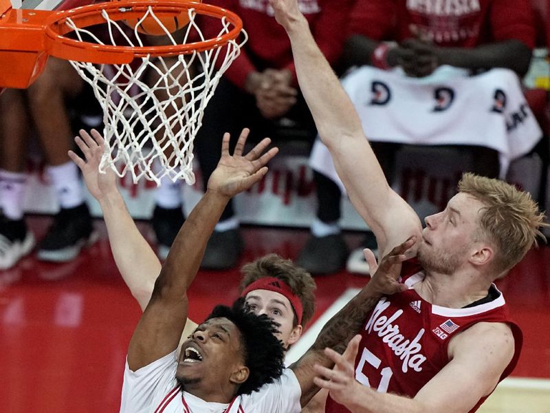 Jan 6, 2024; Madison, Wisconsin, USA; Wisconsin guard Kamari McGee (4) scores on Nebraska forward Rienk Mast (51) during the first half at Kohl Center. Mandatory Credit: Mark Hoffman-USA TODAY Sports