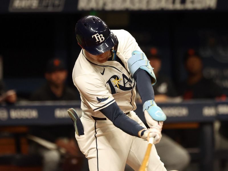 Apr 22, 2024; St. Petersburg, Florida, USA; Tampa Bay Rays second baseman Curtis Mead (25) singles against the Detroit Tigers during the third inning at Tropicana Field. Mandatory Credit: Kim Klement Neitzel-USA TODAY Sports