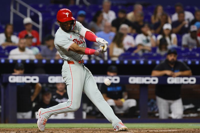 Sep 6, 2024; Miami, Florida, USA; Philadelphia Phillies center fielder Johan Rojas (18) hits a double against the Miami Marlins during the second inning at loanDepot Park. Mandatory Credit: Sam Navarro-Imagn Images