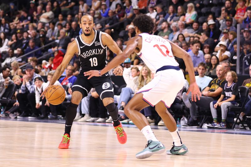 OCEANSIDE, CALIFORNIA - OCTOBER 08: Amari Bailey #10 of the Brooklyn Nets controls the ball against Cam Christie #12 of the Los Angeles Clippers in the fourth quarter of the preseason game at Frontwave Arena on October 08, 2024 in Oceanside, California. NOTE TO USER: User expressly acknowledges and agrees that, by downloading and or using this photograph, User is consenting to the terms and conditions of the Getty Images License Agreement. (Photo by Joe Scarnici/Getty Images)