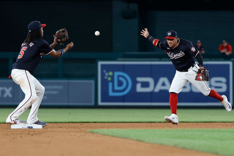 Jun 4, 2024; Washington, District of Columbia, USA; Washington Nationals second base Ildemaro Vargas (14) tosses the ball to Nationals shortstop CJ Abrams (5) on a ground ball by New York Mets shortstop Jose Iglesias (not pictured) during the eighth inning at Nationals Park. Mandatory Credit: Geoff Burke-USA TODAY Sports