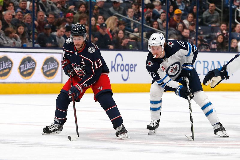 Feb 16, 2023; Columbus, Ohio, USA; Columbus Blue Jackets left wing Johnny Gaudreau (13) carries the puck as Winnipeg Jets center Mason Appleton (22) trails the play during the second period at Nationwide Arena. Mandatory Credit: Russell LaBounty-USA TODAY Sports