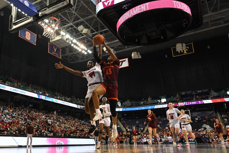 Mar 5, 2023; Greensboro, NC, USA; Virginia Tech Hokies forward Taylor Soule (13) shoots over Louisville Cardinals forward Olivia Cochran (44) during the second half at Greensboro Coliseum. Mandatory Credit: William Howard-USA TODAY Sports