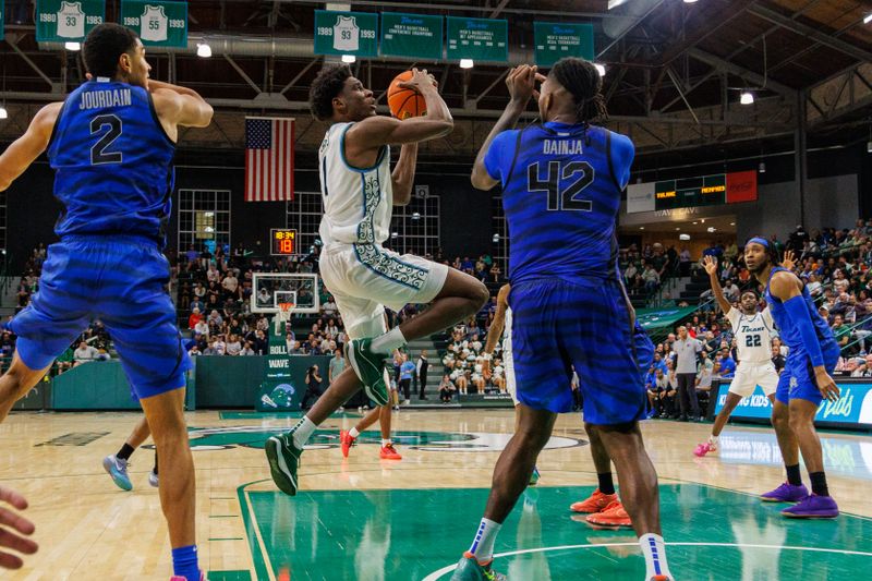 Jan 30, 2025; New Orleans, Louisiana, USA;  Tulane Green Wave forward Kaleb Banks (1) drives to the basket against Memphis Tigers forward Dain Dainja (42) during the second half at Avron B. Fogelman Arena in Devlin Fieldhouse. Mandatory Credit: Stephen Lew-Imagn Images