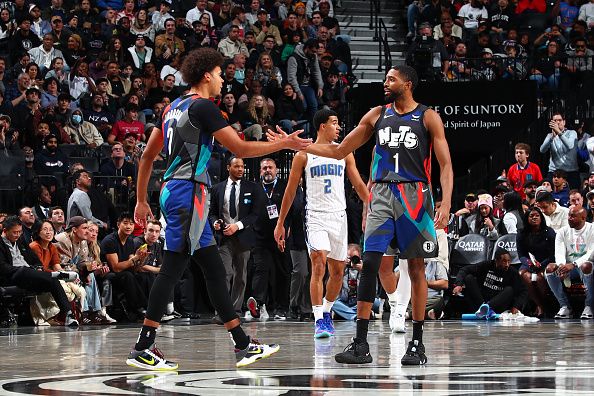 BROOKLYN, NY - DECEMBER 2: Cameron Johnson #2 and Mikal Bridges #1 of the Brooklyn Nets high five during the game against the Orlando Magic on December 2, 2023 at Barclays Center in Brooklyn, New York. NOTE TO USER: User expressly acknowledges and agrees that, by downloading and or using this Photograph, user is consenting to the terms and conditions of the Getty Images License Agreement. Mandatory Copyright Notice: Copyright 2023 NBAE (Photo by David L. Nemec/NBAE via Getty Images)