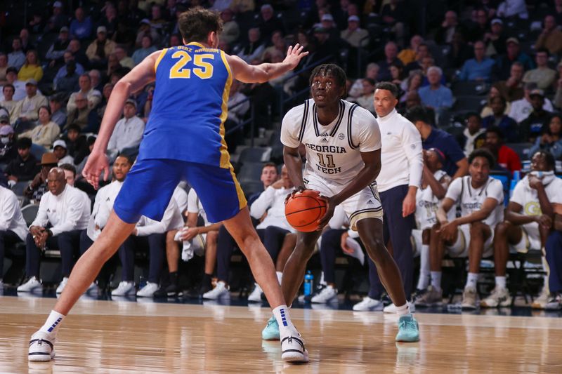 Jan 23, 2024; Atlanta, Georgia, USA; Georgia Tech Yellow Jackets forward Baye Ndongo (11) is defended by Pittsburgh Panthers forward Guillermo Diaz Graham (25) in the second half at McCamish Pavilion. Mandatory Credit: Brett Davis-USA TODAY Sports
