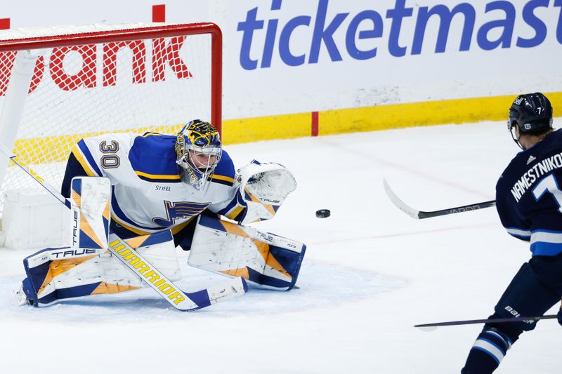 Feb 27, 2024; Winnipeg, Manitoba, CAN; St. Louis Blues goalie Joel Hofer (30) makes a save on a shot by Winnipeg Jets forward Vladislav Namestnikov (7) during the third period at Canada Life Centre. Mandatory Credit: Terrence Lee-USA TODAY Sports