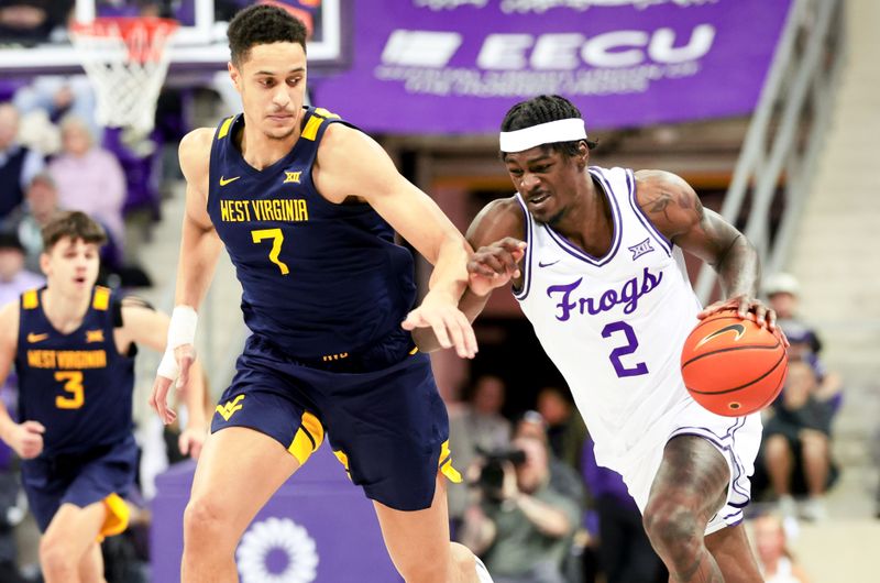 Feb 12, 2024; Fort Worth, Texas, USA;  TCU Horned Frogs forward Emanuel Miller (2) controls the ball as West Virginia Mountaineers center Jesse Edwards (7) defends during the first half at Ed and Rae Schollmaier Arena. Mandatory Credit: Kevin Jairaj-USA TODAY Sports