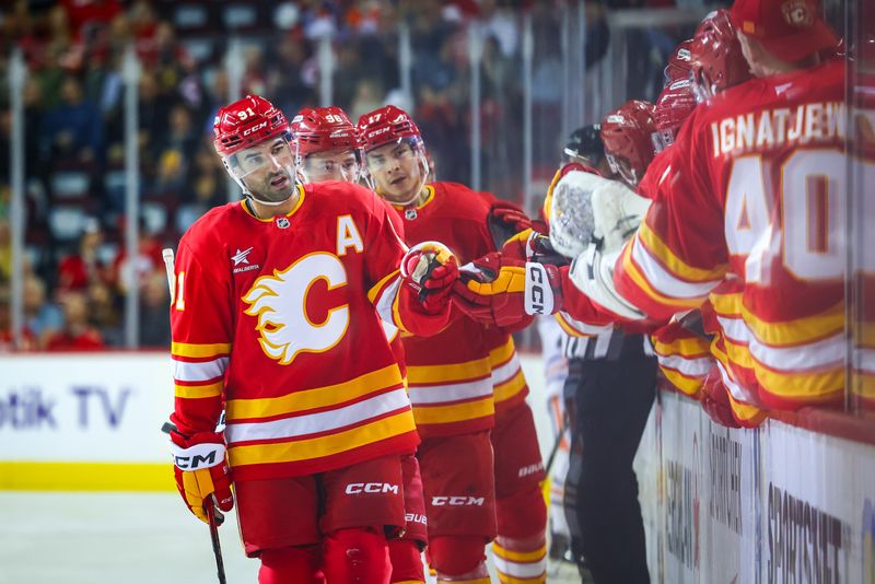 Sep 23, 2024; Calgary, Alberta, CAN; Calgary Flames center Nazem Kadri (91) celebrates his goal with teammates against the Edmonton Oilers during the first period at Scotiabank Saddledome. Mandatory Credit: Sergei Belski-Imagn Images