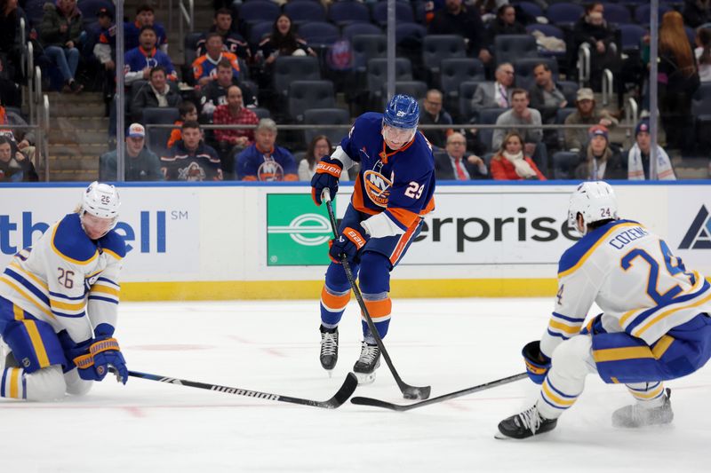 Nov 30, 2024; Elmont, New York, USA; New York Islanders center Brock Nelson (29) takes a shot against Buffalo Sabres defenseman Rasmus Dahlin (26) and center Dylan Cozens (24) during the second period at UBS Arena. Mandatory Credit: Brad Penner-Imagn Images