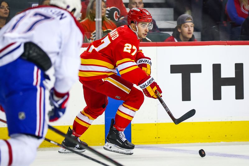 Oct 22, 2025; Calgary, Alberta, CAN; Calgary Flames right wing Matt Coronato (27) controls the puck against the Montreal Canadiens during the first period at Scotiabank Saddledome. Mandatory Credit: Sergei Belski-Imagn Images