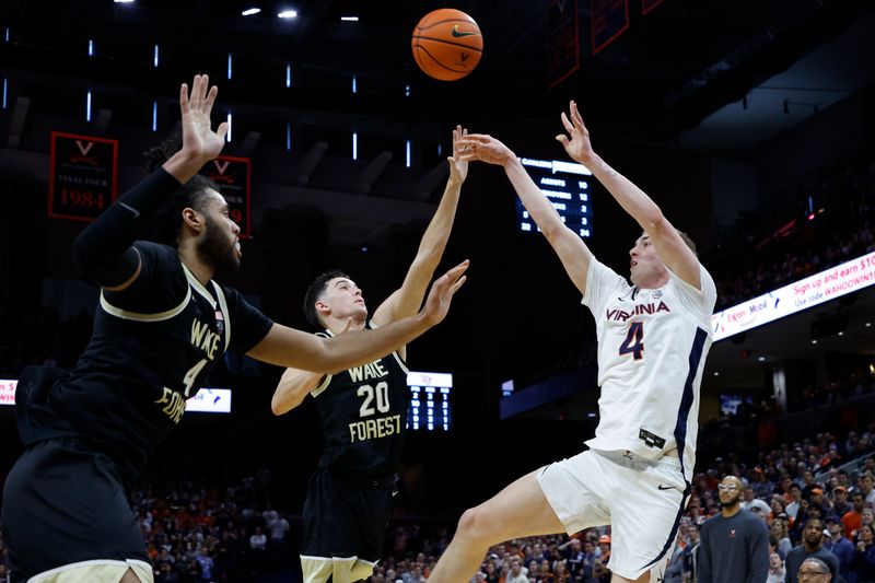 Feb 17, 2024; Charlottesville, Virginia, USA; Virginia Cavaliers guard Andrew Rohde (4) shoots the ball as Wake Forest Demon Deacons guard Parker Friedrichsen (20) and Demon Deacons forward Efton Reid III (4) defend in the second half at John Paul Jones Arena. Mandatory Credit: Geoff Burke-USA TODAY Sports