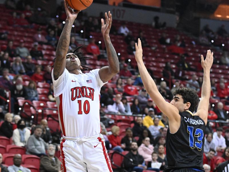 Feb 14, 2023; Las Vegas, Nevada, USA; UNLV Runnin' Rebels guard Keshon Gilbert (10) shoots over San Jose State Spartans guard Alvaro Cardenas (13) in the first half at Thomas & Mack Center. Mandatory Credit: Candice Ward-USA TODAY Sports