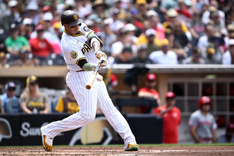 May 1, 2024; San Diego, California, USA; San Diego Padres third baseman Manny Machado (13) hits a single against the Cincinnati Reds during the third inning at Petco Park. Mandatory Credit: Orlando Ramirez-USA TODAY Sports