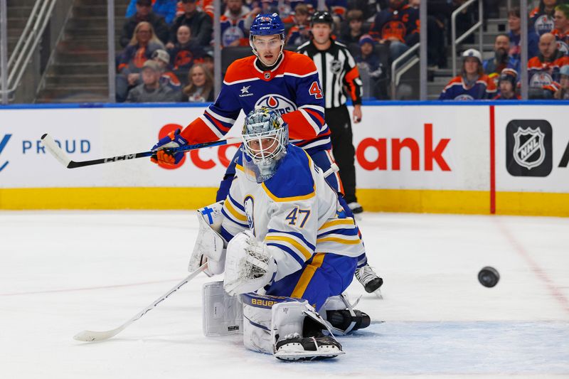 Jan 25, 2025; Edmonton, Alberta, CAN; Buffalo Sabres goaltender James Reimer (47) and Edmonton Oilers forward Noah Philp (48) watch a shot go wide of the net during the first period at Rogers Place. Mandatory Credit: Perry Nelson-Imagn Images