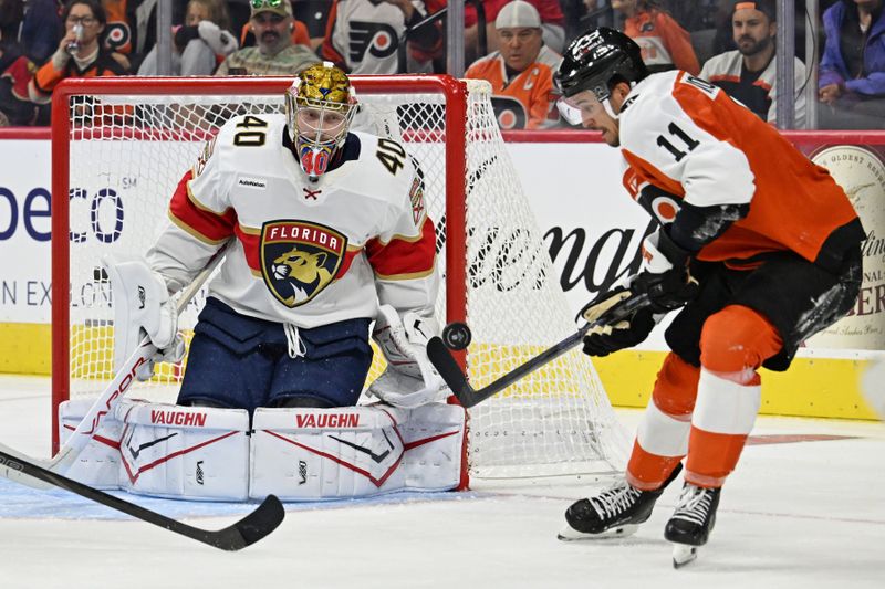 Oct 13, 2025; Philadelphia, Pennsylvania, USA; Philadelphia Flyers right wing Travis Konecny (11) and Florida Panthers goaltender Daniil Tarasov (40) battle for the puck during the second period at Wells Fargo Center. Mandatory Credit: Eric Hartline-Imagn Images