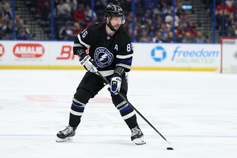 Feb 17, 2024; Tampa, Florida, USA;  Tampa Bay Lightning right wing Nikita Kucherov (86) controls the puck against the Florida Panthers in the third period at Amalie Arena. Mandatory Credit: Nathan Ray Seebeck-USA TODAY Sports