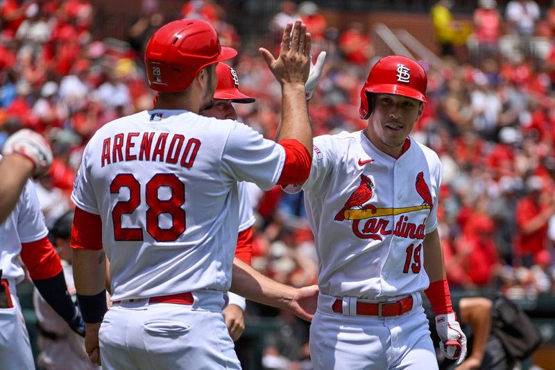 Jun 14, 2023; St. Louis, Missouri, USA;  St. Louis Cardinals center fielder Tommy Edman (19) celebrates with designated hitter Nolan Arenado (28) after hitting a grand slam against the San Francisco Giants during the second inning at Busch Stadium. Mandatory Credit: Jeff Curry-USA TODAY Sports