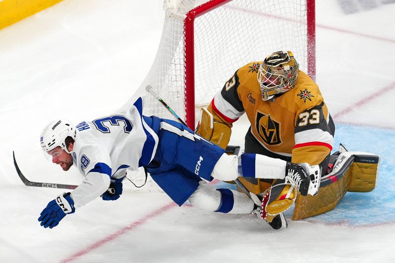 Mar 19, 2024; Las Vegas, Nevada, USA; Tampa Bay Lightning left wing Brandon Hagel (38) is tripped by Vegas Golden Knights goaltender Adin Hill (33) during the third period at T-Mobile Arena. Mandatory Credit: Stephen R. Sylvanie-USA TODAY Sports