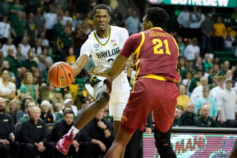 Mar 4, 2023; Waco, Texas, USA; Baylor Bears guard Dale Bonner (3) looks to pass the ball around Iowa State Cyclones center Osun Osunniyi (21) during the second half at Ferrell Center. Mandatory Credit: Raymond Carlin III-USA TODAY Sports