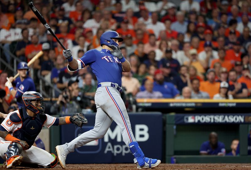 Oct 23, 2023; Houston, Texas, USA; Texas Rangers first baseman Nathaniel Lowe (30) hits a two-run home run during the sixth inning of game seven in the ALCS against the Houston Astros for the 2023 MLB playoffs at Minute Maid Park. Mandatory Credit: Thomas Shea-USA TODAY Sports