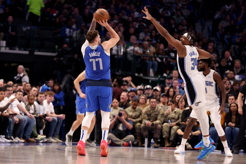 DALLAS, TEXAS - JANUARY 29: Luka Doncic #77 of the Dallas Mavericks shoots the ball against Wendell Carter Jr. #34 of the Orlando Magic in the first half at American Airlines Center on January 29, 2024 in Dallas, Texas. NOTE TO USER: User expressly acknowledges and agrees that, by downloading and or using this photograph, User is consenting to the terms and conditions of the Getty Images License Agreement. (Photo by Tim Heitman/Getty Images)