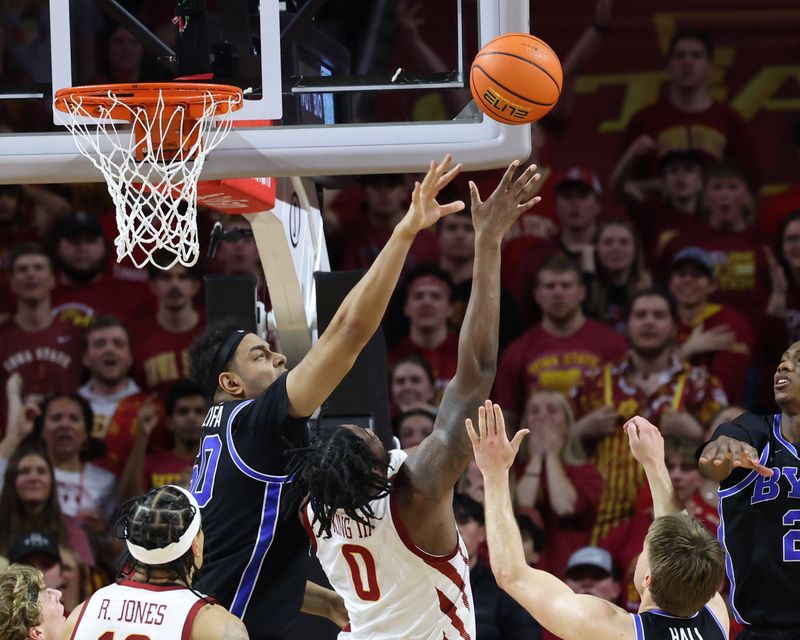 Mar 6, 2024; Ames, Iowa, USA; Brigham Young Cougars center Aly Khalifa (50) defends the shot from Iowa State Cyclones forward Tre King (0) in the second half at James H. Hilton Coliseum. Mandatory Credit: Reese Strickland-USA TODAY Sports

