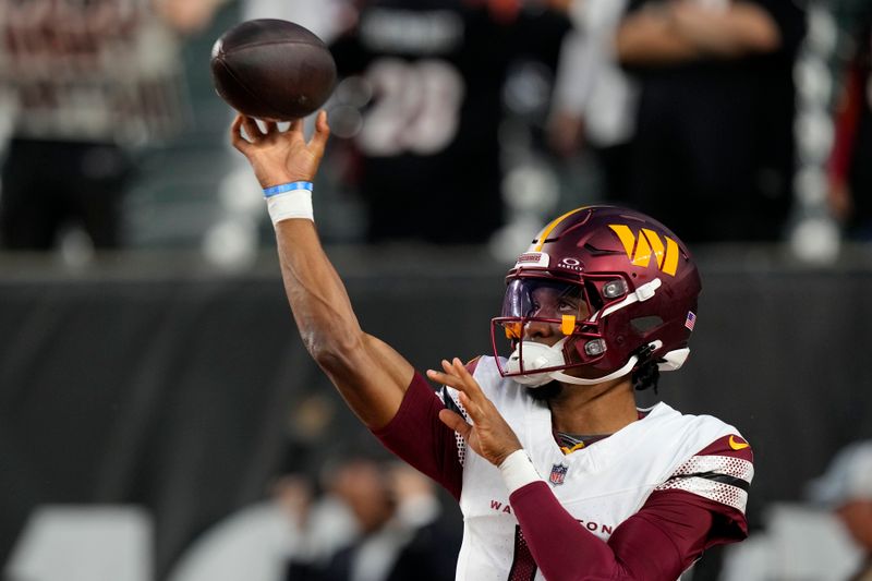 Washington Commanders quarterback Jayden Daniels warms up before an NFL football game against the Cincinnati Bengals, Monday, Sept. 23, 2024, in Cincinnati. (AP Photo/Carolyn Kaster)