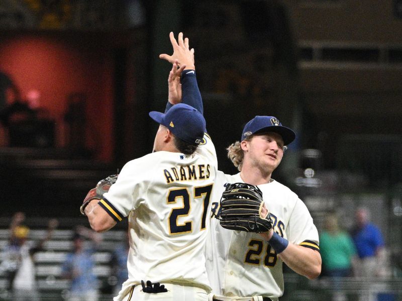May 23, 2023; Milwaukee, Wisconsin, USA; Milwaukee Brewers right fielder Joey Wiemer (28) and Milwaukee Brewers shortstop Willy Adames (27) celebrate defeating  the Houston Astros at American Family Field. Mandatory Credit: Michael McLoone-USA TODAY Sports