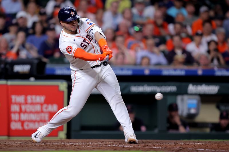 Apr 30, 2024; Houston, Texas, USA; Houston Astros catcher Yainer Diaz (21) hits a single against the Cleveland Guardians during the fourth inning at Minute Maid Park. Mandatory Credit: Erik Williams-USA TODAY Sports