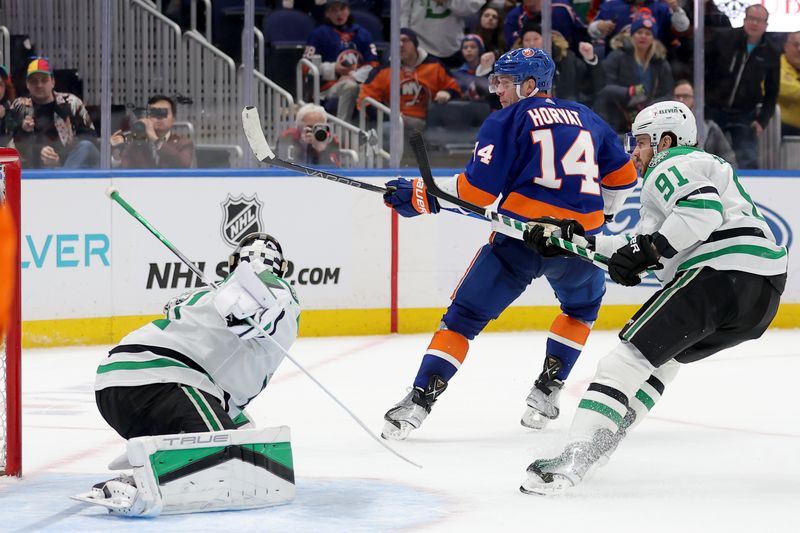 Jan 21, 2024; Elmont, New York, USA; New York Islanders center Bo Horvat (14) looks back after scoring the game winning goal against Dallas Stars goaltender Scott Wedgewood (41) and center Tyler Seguin (91) during overtime at UBS Arena. Mandatory Credit: Brad Penner-USA TODAY Sports