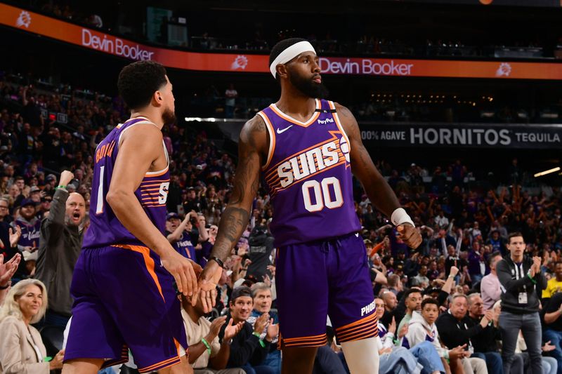 PHOENIX, AZ - NOVEMBER 6: Royce O'Neale #00  and Devin Booker #1 of the Phoenix Suns high five during the game against the Miami Heat on November 6, 2024 at Footprint Center in Phoenix, Arizona. NOTE TO USER: User expressly acknowledges and agrees that, by downloading and or using this photograph, user is consenting to the terms and conditions of the Getty Images License Agreement. Mandatory Copyright Notice: Copyright 2024 NBAE (Photo by Kate Frese/NBAE via Getty Images)