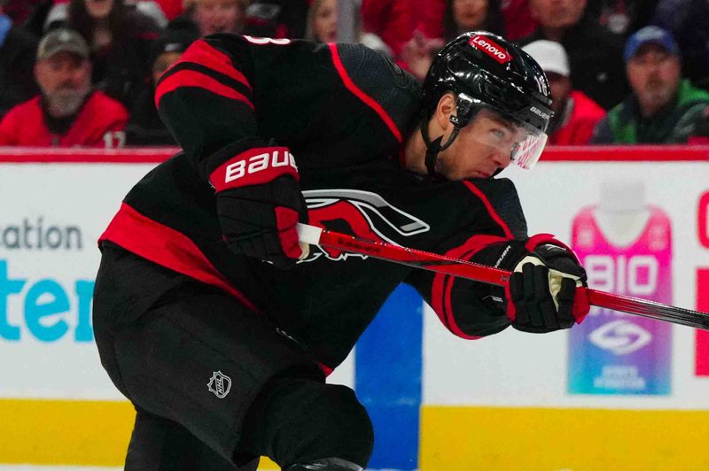 Nov 24, 2023; Raleigh, North Carolina, USA; Carolina Hurricanes center Jack Drury (18) takes a shot against the Tampa Bay Lightning during the first period at PNC Arena. Mandatory Credit: James Guillory-USA TODAY Sports