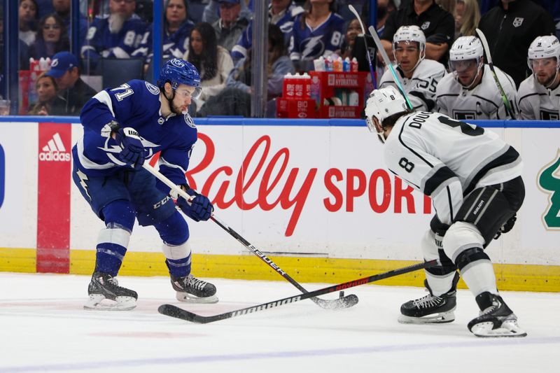 Jan 28, 2023; Tampa, Florida, USA;  Tampa Bay Lightning center Anthony Cirelli (71) controls the puck  from Los Angeles Kings defenseman Drew Doughty (8) in the first period  at Amalie Arena. Mandatory Credit: Nathan Ray Seebeck-USA TODAY Sports