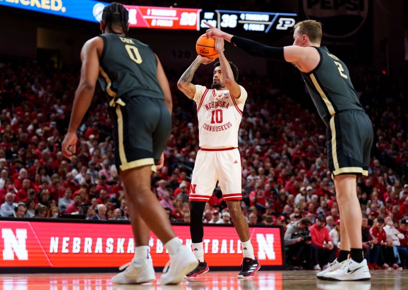 Feb 10, 2026; Lincoln, Nebraska, USA; Nebraska Cornhuskers guard Jamarques Lawrence (10) shoots a free throw against Purdue Boilermakers guard C.J. Cox (0) and guard Fletcher Loyer (2) during the first half at Pinnacle Bank Arena. Mandatory Credit: Dylan Widger-Imagn Images