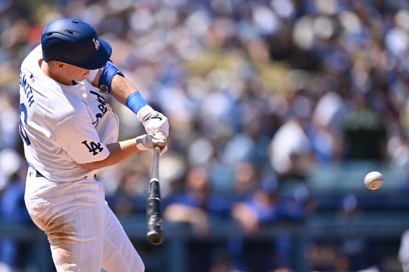 Apr 21, 2024; Los Angeles, California, USA; Los Angeles Dodgers catcher Will Smith (16) hits a one run double against the New York Mets during the fifth inning at Dodger Stadium. Mandatory Credit: Jonathan Hui-USA TODAY Sports