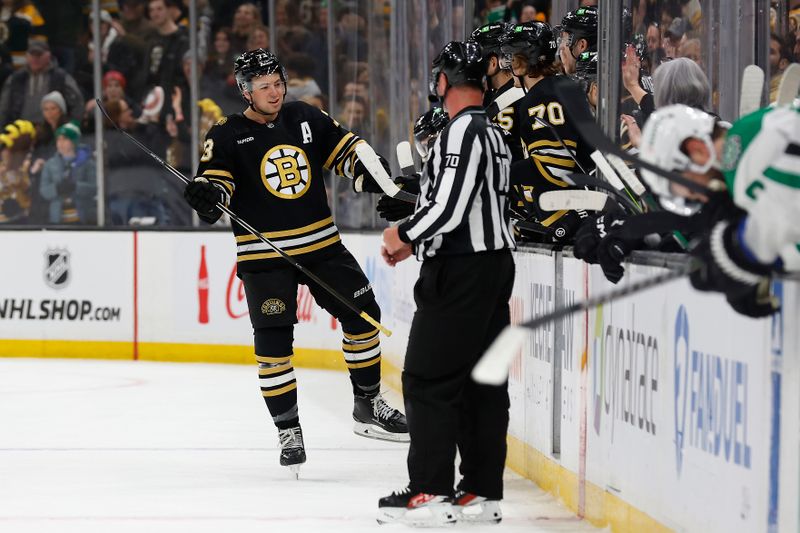 Feb 19, 2024; Boston, Massachusetts, USA; Boston Bruins defenseman Charlie McAvoy (73) smiles as he is congratulated at the bench after scoring the winning goal in a shootout against the Dallas Stars at TD Garden. Mandatory Credit: Winslow Townson-USA TODAY Sports