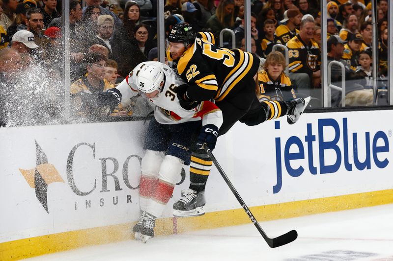 Oct 14, 2024; Boston, Massachusetts, USA; Boston Bruins defenseman Andrew Peeke (52) tries to check Florida Panthers right wing Patrick Giles (36) during the third period at TD Garden. Mandatory Credit: Winslow Townson-Imagn Images