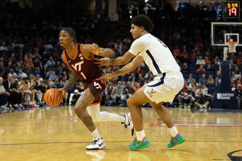 Feb 1, 2025; Charlottesville, Virginia, USA; Virginia Tech Hokies forward Tobi Lawal (1) dribbles the ball as Virginia Cavaliers forward Jacob Cofie (5) defends at John Paul Jones Arena. Mandatory Credit: Emily Morgan-Imagn Images