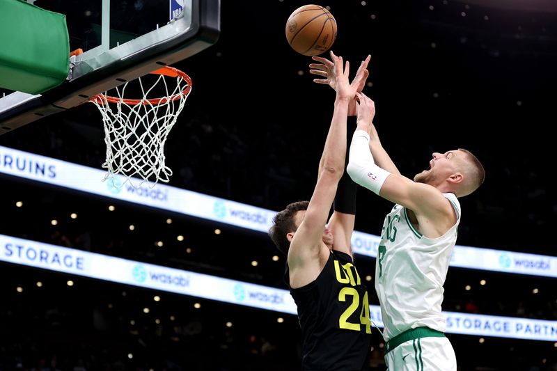 BOSTON, MASSACHUSETTS - JANUARY 05: Walker Kessler #24 of the Utah Jazz fouls Kristaps Porzingis #8 of the Boston Celtics during the second quarter at TD Garden on January 05, 2024 in Boston, Massachusetts. NOTE TO USER: User expressly acknowledges and agrees that, by downloading and or using this photograph, user is consenting to the terms and conditions of the Getty Images License Agreement.  (Photo by Maddie Meyer/Getty Images)