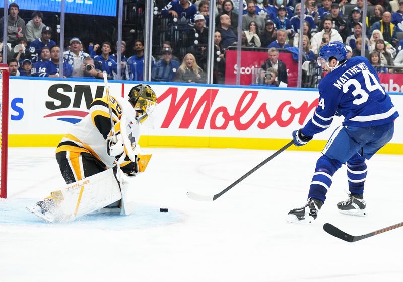 Oct 12, 2024; Toronto, Ontario, CAN; Toronto Maple Leafs center Auston Matthews (34) attempts a shot on Pittsburgh Penguins goaltender Joel Blomqvist (30) during the third period at Scotiabank Arena. Mandatory Credit: Nick Turchiaro-Imagn Images