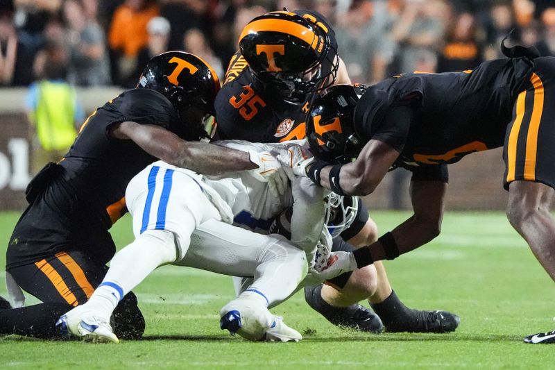 Nov 2, 2024; Knoxville, Tennessee, USA; Kentucky Wildcats running back Jamarion Wilcox (10) is taken down by Tennessee Volunteers defensive back Andre Turrentine (2), defensive back Will Brooks (35), and defensive back Jermod McCoy (3) during during the first half at Neyland Stadium. Mandatory Credit: Caitie McMekin/USA TODAY Network via Imagn Images
